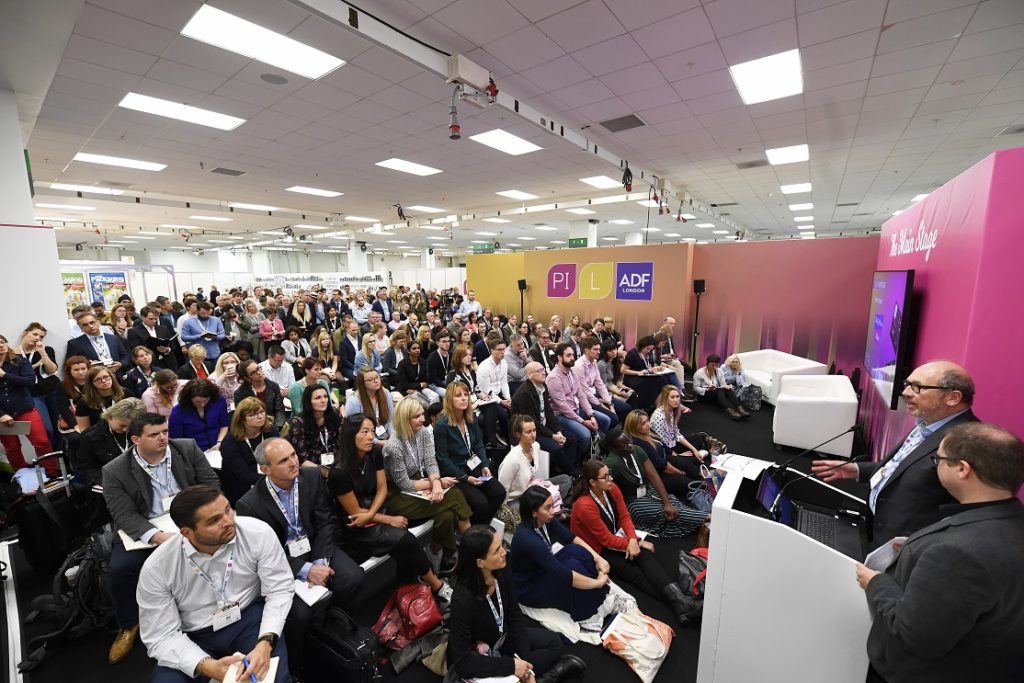 Ecopack Challenge targets sustainable packaging ideas crowd listening to talk at packaging event
