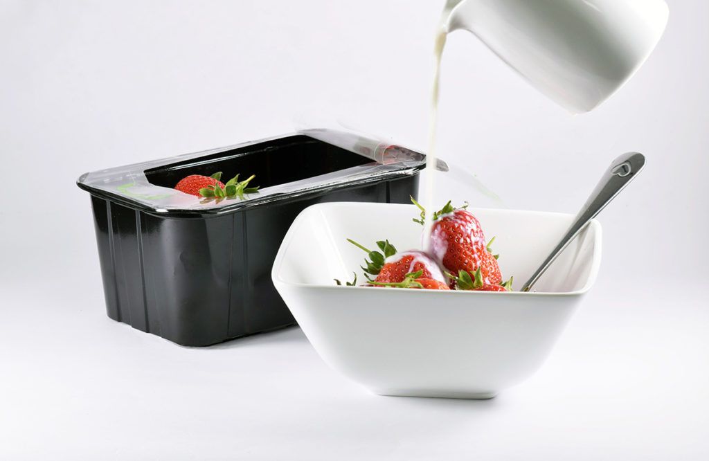 Reclose lidding film created for Dutch soft fruits market cream being poured on strawberries