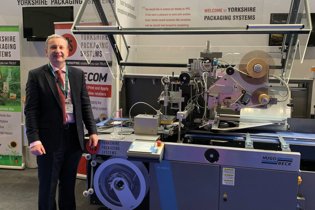 Glyn infront of stall with machinery