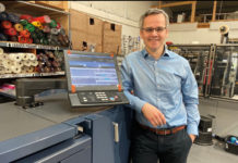 Glasgow firm presses on with growth plans man standing by screen in shop