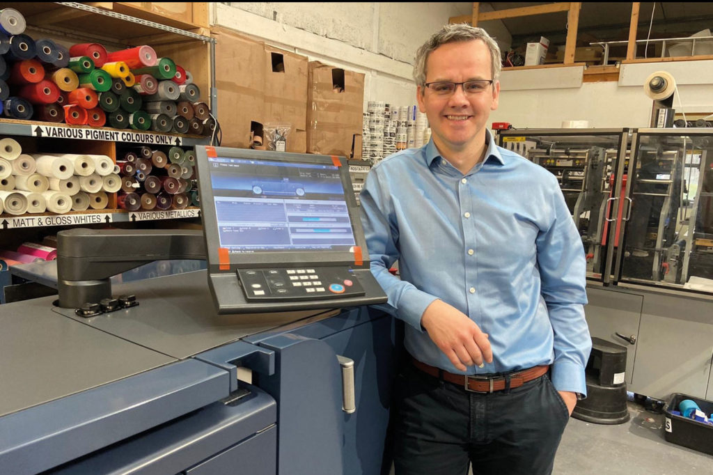man standing by screen in shop