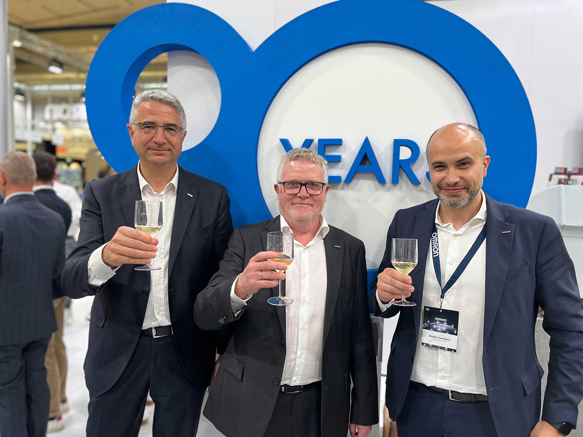 OMRON employees holding glasses of champagne.
