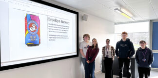 Students with image of Undergraduate Can of the Year award winner
