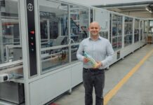 Fruglapac Product Director JP Grogan and the new Frugal Bottle Assembly Machine 2 (FBAM-2)