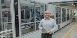Fruglapac Product Director JP Grogan and the new Frugal Bottle Assembly Machine 2 (FBAM-2)
