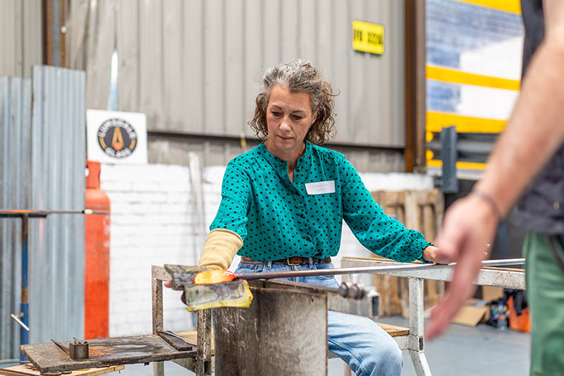 Rotherham MP Sarah Champion gets some hands-on experience of how glass used to be made