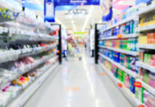 Supermarket in blurry background displaying various types of packaging