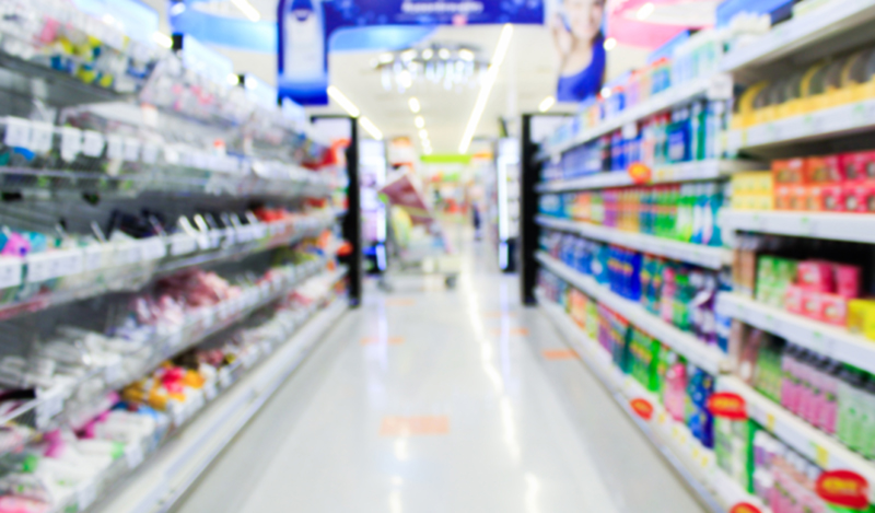 Supermarket in blurry background displaying various types of packaging