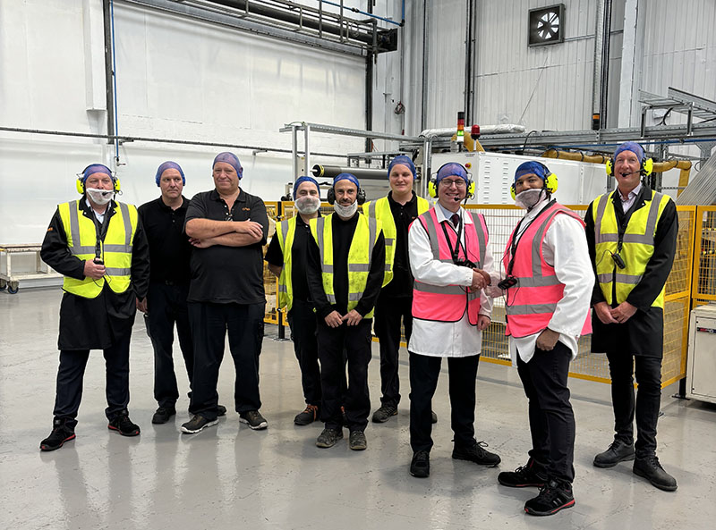 Andrew Cooper MP (third from right) and Sujoy Bose, Coveris Winsford Managing Director (second from right) alongside Coveris Winsford employees for the conversion hall opening.
