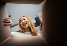Online retailers are boxing clever over packaging improvements Consumer opening a box. Unboxing image