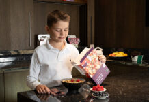 Child pouring breakfast cereal