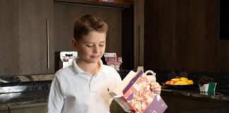 Child pouring breakfast cereal